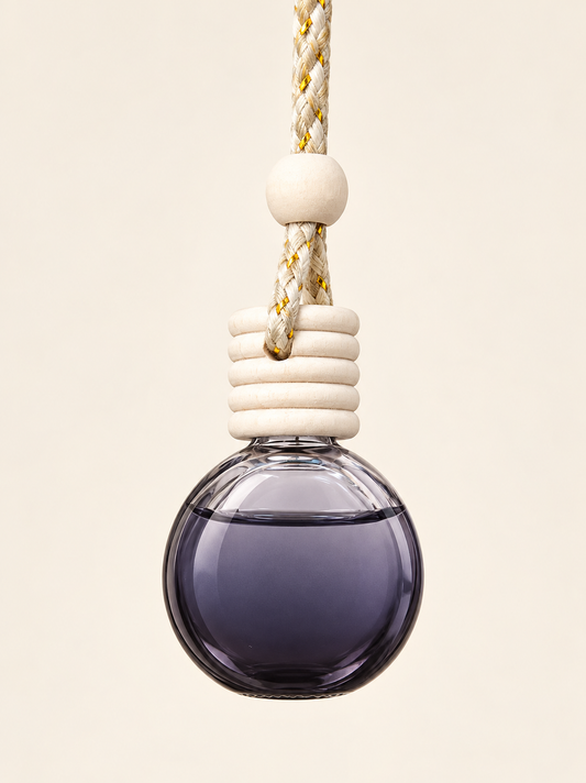Round smoky glass car diffuser with white wooden cap and cream cord