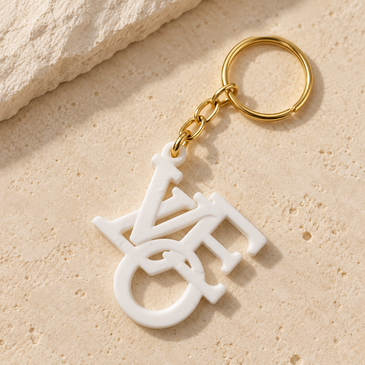 White LVOE word-art keychain with gold-tone chain and split ring