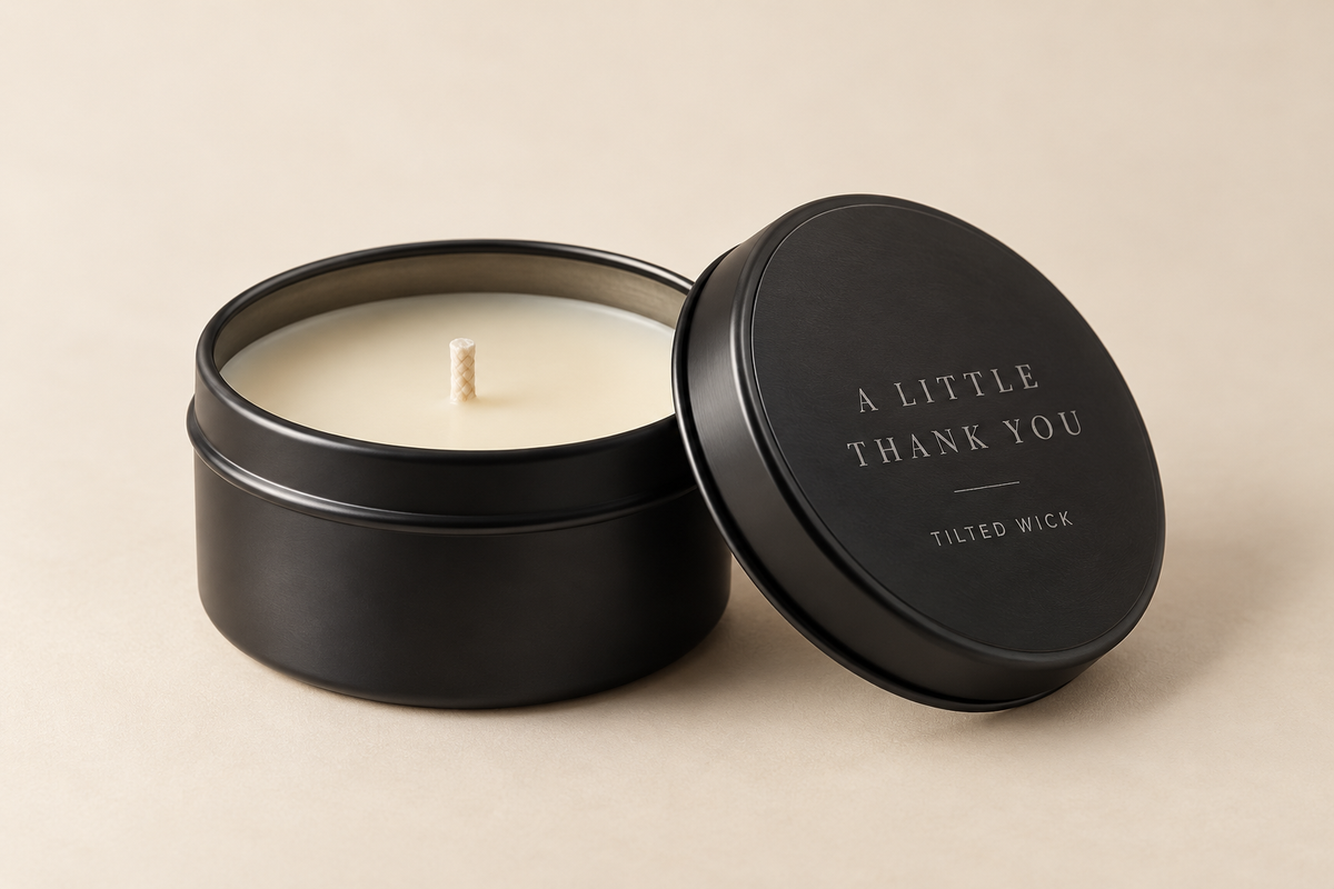 Concept mockup of a 2 oz candle tin with example lid engraving